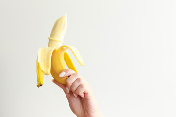 Fototapeta na wymiar banana with a condom on a white background. contraceptives.