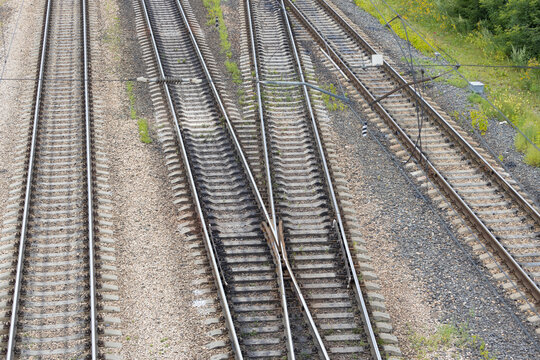 Railway tracks interchanges. A railway junction. Crossing parallel railroad tracks. Industrial background. Top view