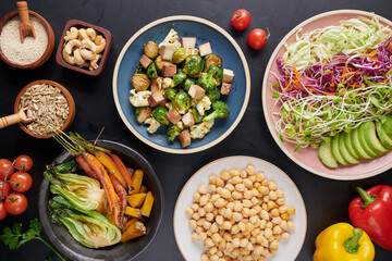 Vegan protein source. Buddha bowl dish, avocado, pepper, tomato, cucumber, red cabbage, chickpea, fresh lettuce salad and walnuts, nuts, beans, . Healthy vegetarian eating, super food. Top view.