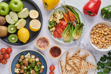 Vegan protein source. Buddha bowl dish, avocado, pepper, tomato, cabbage, chickpea, toast, bread fresh lettuce salad and walnuts, nuts, beans. Healthy vegetarian eating, super food. Top view.