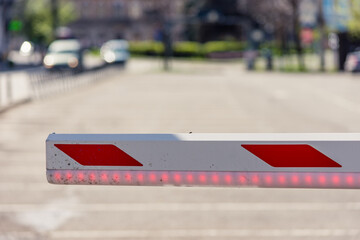 Close up to an empty parking barrier with LED band for warning