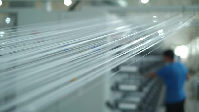 Operator works on polymer thread winding machine