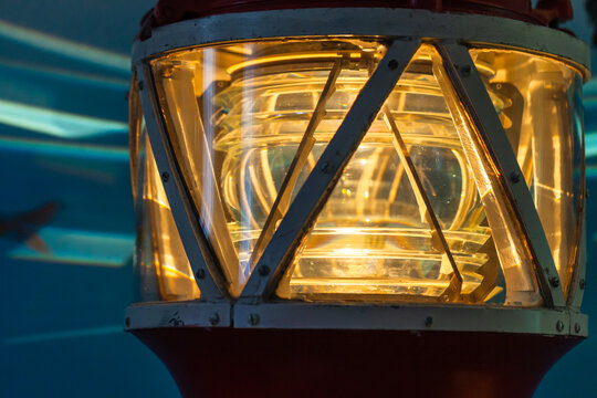 Yellow lighthouse lamp glows in metal frame