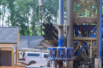 Portable hydraulic well drilling rig located on water extraction a land plot owned by the owner - obrazy, fototapety, plakaty