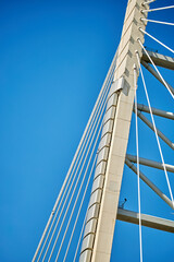 Ropes of a cable-stayed bridge against a blue sky