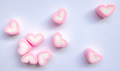 Fototapeta premium Rows of pink and white heart shaped marshmallow candies. Marshmallows in the shape of a heart on background. Valentine's day concept fill heart for full of love.