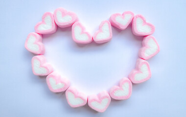 Rows of pink and white heart shaped marshmallow candies. Marshmallows in the shape of a heart on background. Fill heart for full of love , small hearts lined up to form a large heart.