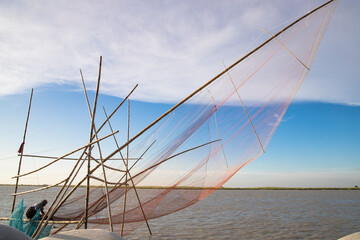 Traditional Fishing net Vessel 
 in padma river under the open blue sky