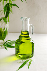 Cannabis CBD hemp oil in a glass bottle. The concept of Alternative Oil. Vertical orientation. Selective focus
