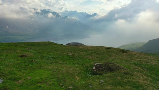 Aerial Forward Shot Of Fort De Ronce On Hill By Mont Cenis Lake Under Cloudy Sky - Val-Cenis, France
