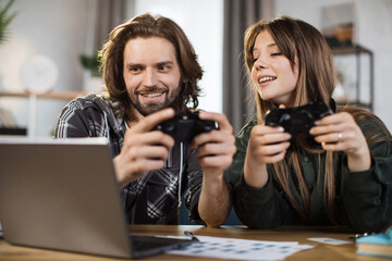 Games, entertainment, family, leisure concept. Close up of young caucasian family, holding joysticks and enjoying their free time playing new games at home.