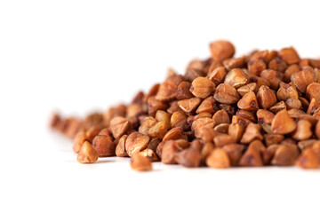 Pile of buckwheat seeds isolated on white background, closeup