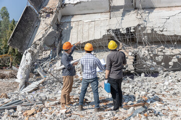 Engineer architect and worker operation control demolish old building.