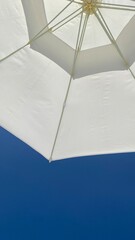 A picture taken under the summer sky and parasols.
