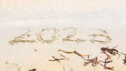 2023 happy New Year coming concept 2023 happy New Year coming concept, numbers 2023 on the sand near the sea