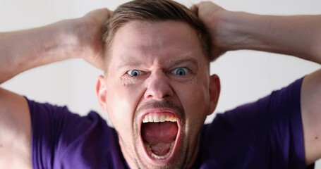 Portrait of screaming angry young handsome man