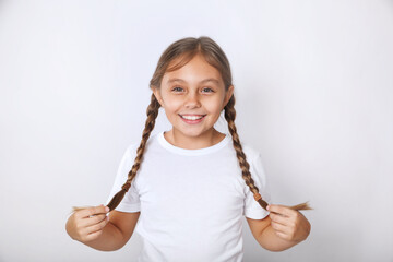 Portrait of nice funny cheerful positive pre-teen girl wearing white t-shirt having fun on white...
