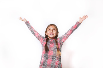 Happy kid girl in plaid dress holding hands up on white background