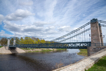 The old suspension bridge over the Velikaya River. The city of Ostrov, Pskov region. Russia