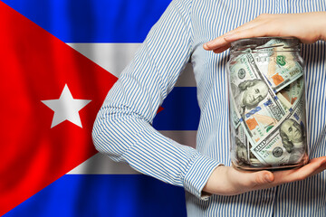 American dollars cash money in hand on Cuban flag background