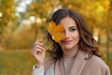 Poster Outdoor atmospheric lifestyle portrait of young beautiful lady. Warm autumn © millaf