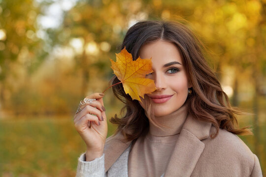 Outdoor atmospheric lifestyle portrait of young beautiful lady. Warm autumn