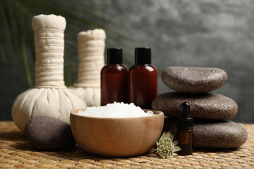 Beautiful spa composition with bath salt on wicker mat