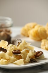 Tasty tagliatelle with truffle on table, closeup