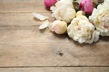 Beautiful peonies on wooden background. Space for text