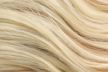 Beautiful blonde hair as background, closeup view