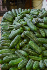 Baby cucumbers placed on a shelf for sale within a market