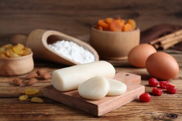 Marzipan and other ingredients for homemade Stollen on wooden table. Baking traditional German Christmas bread