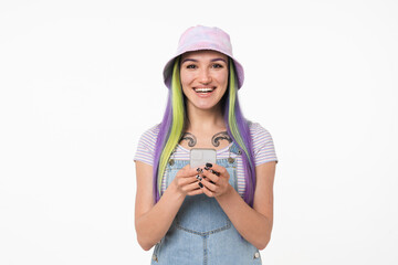 Cheerful caucasian young teenager woman girl with dyed bright hair and tattoo using smart phone online, surfing social media, e-banking, e-learning isolated in white background