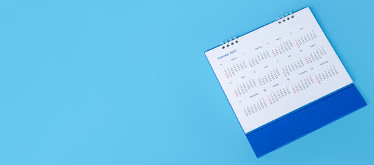 white desk calendar on blue background