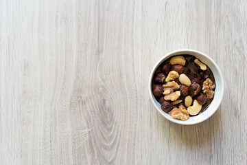 roasted nuts with melted chocolate in a bowl