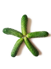 fresh cucumbers arranged in star shape isolated on white background