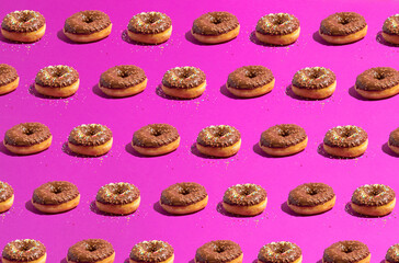 Fototapeta na wymiar Chocolate donut pattern on a purple background viewed.Isometric view