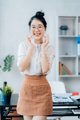 Portrait of beautiful Asian businesswoman manager with a smile standing holding document at the office