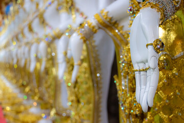 Close-up view of hand gesture of oriental statues of deities in a Buddhist temple