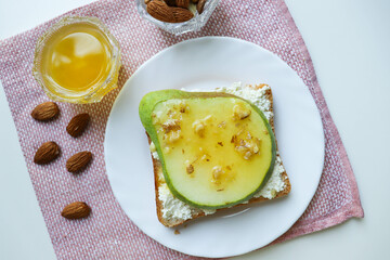 healthy food. healthy breakfast. sandwich with cottage cheese, pear, honey and nuts