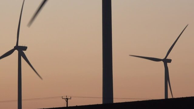 Wind turbines in the evening light with green energy North England. Renewable power UK 4K