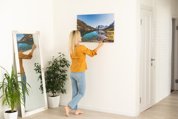 Young woman in yellow blouse hold canvas. Minimal art concept.