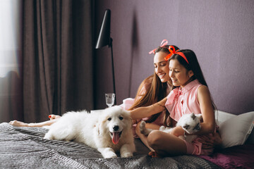 Mother and daughter with kitten and dog © Petro