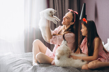 Mother and daughter with kitten and dog