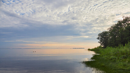 Coast of Gulf of Finland of Baltic Sea: calm, sunset, clouds, idyll, dubki park.