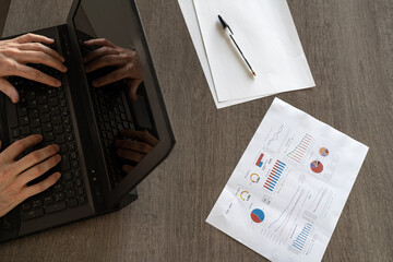 Employee comfortably teleworking from somewhere on his computer combining life and work