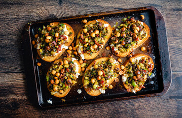 Caramelized Brussels Sprout Toast with Burrata and Bacon on a Sheet Pan: Toasted bread topped with vegetables, mozzarella cheese, and bacon