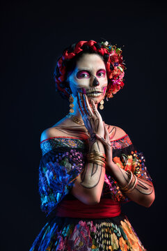 Catrina Woman Dressed In A Mexican Chiapas Costume With A Black Background Pink Rebozo And Skull And Bones Makeup On Her Hands