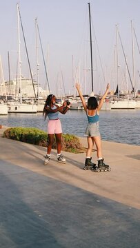 Woman taking photos of friend on the roller blades in the port