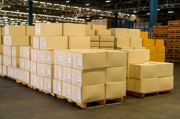 Inventory full of cardboard boxes in modern warehouse storage of retail shop.